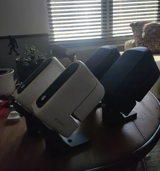 The printed wedges installed beneath two devices, holding them at an angle.