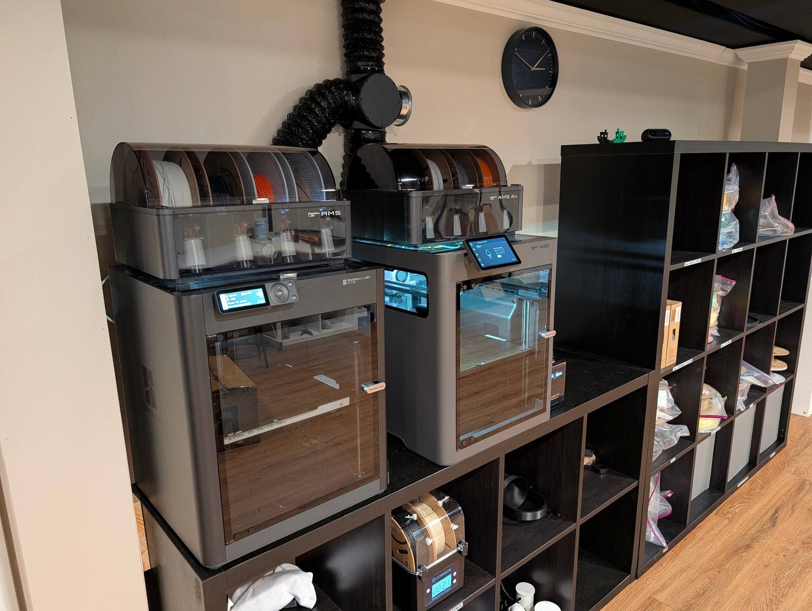 Enclosed 3D printers and filament systems in the Northwoods Craftworks workshop.